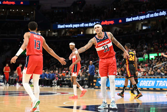 Washington Wizards forward Kyle Kuzma (33) celebrates with guard Jordan Poole (13) during the first half against the Atlanta Hawks at Capital One Arena.